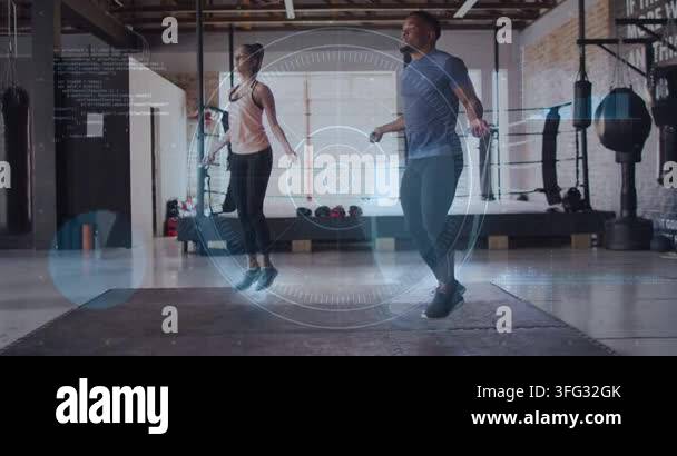 A Frame Rotation Exercise Partners rotating jump-ropes and starting synced jumps in fitness gym ...