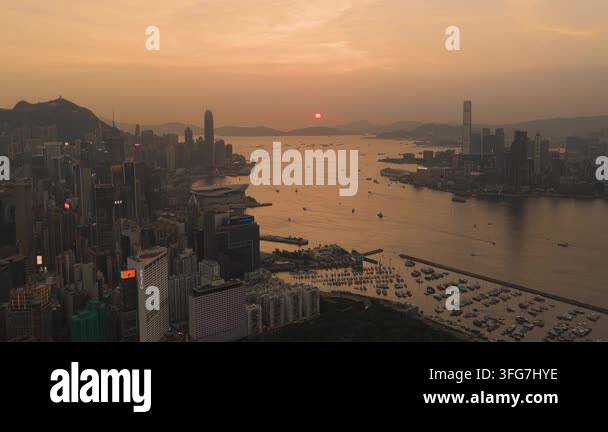 Aerial view of Hong Kong skyline and Victoria Harbour at sunset with ...