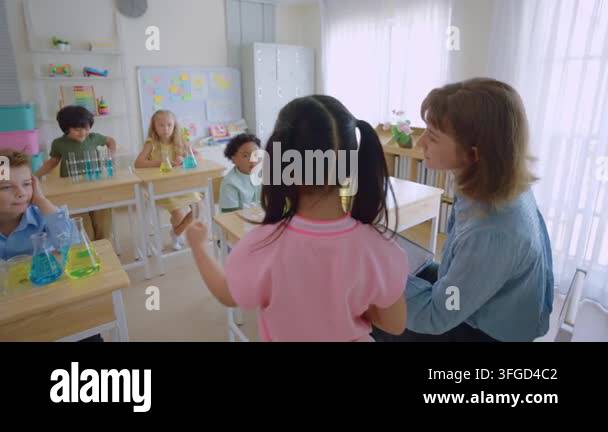 Young Girl Holding A Pencil In A Classroom With Students Sitting At Young Girl Holding A Pencil In A Classroom With Students Sitting At