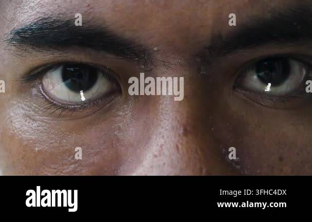 Close up of a man's observant eyes, reflecting light and showing a ...