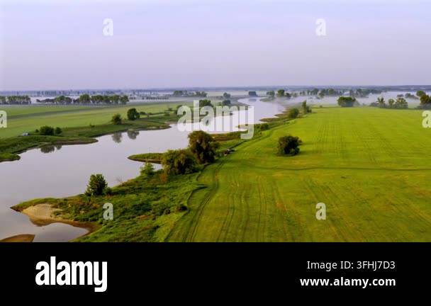 Morning Rural Vector Aerial view of Elbe River at dawn, with mist drifting above green ...
