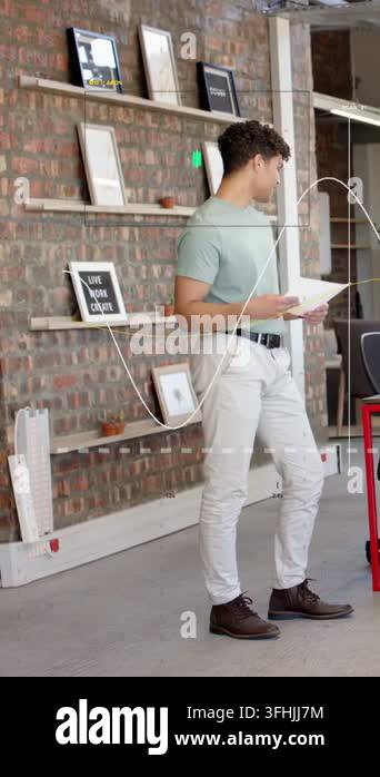 Glanicing Vertical video: Glancing at papers man in sage tee turning right ...