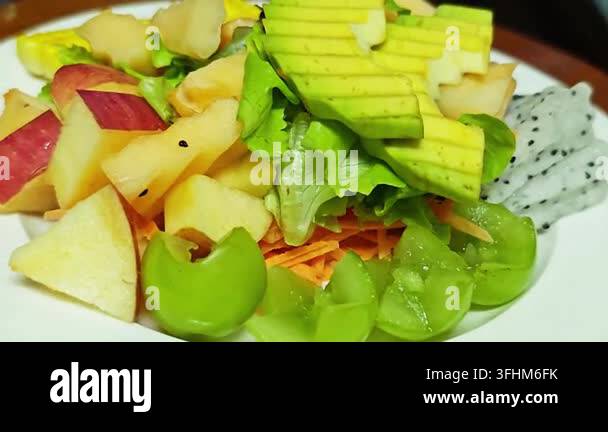 Fresh Fruit And Vegetable Salad Topped With Sliced Avocado Stock Video 