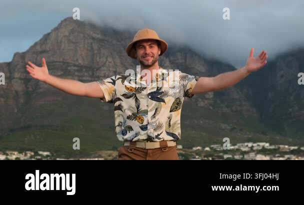 smiling-adult-man-stands-in-welcoming-pose-with-arms-extended-toward