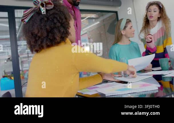 Woman in yellow top reaching for paper, causing holo rings marking ...