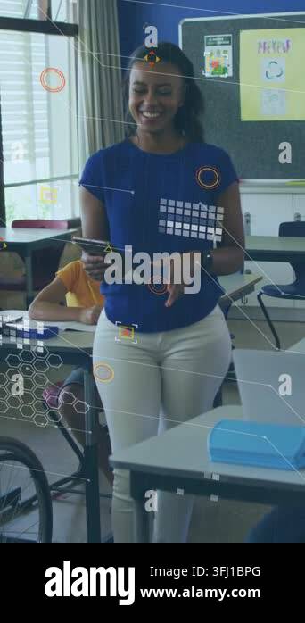 Vertical video: Teacher glancing at tablet, turning to kids and ...