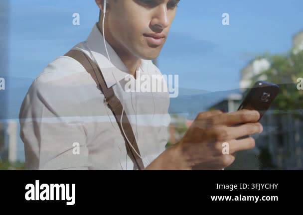 Glanicing Commuter on urban sidewalk glancing at phone and tapping screen ...