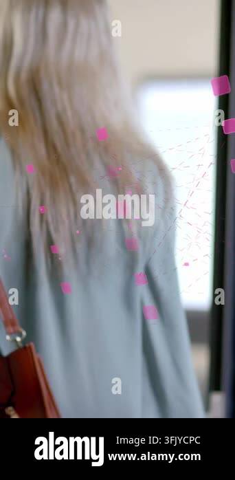 Vertical video: Woman walking into biz hall toward lit panel peer ...