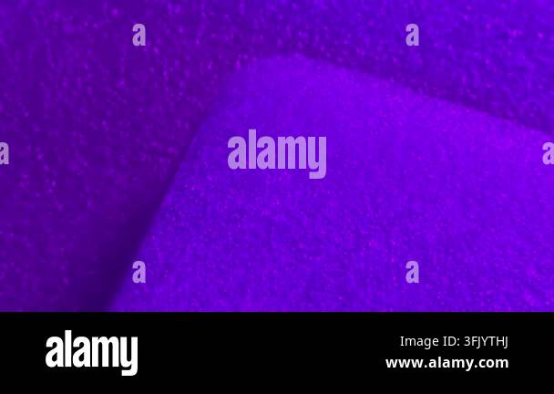 A textured surface with gradients of purple and pink hues, displaying ...