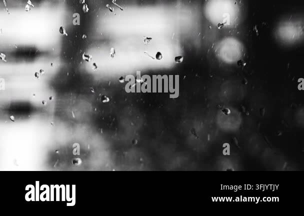Close up of water droplets clinging to a glass pane, creating abstract ...
