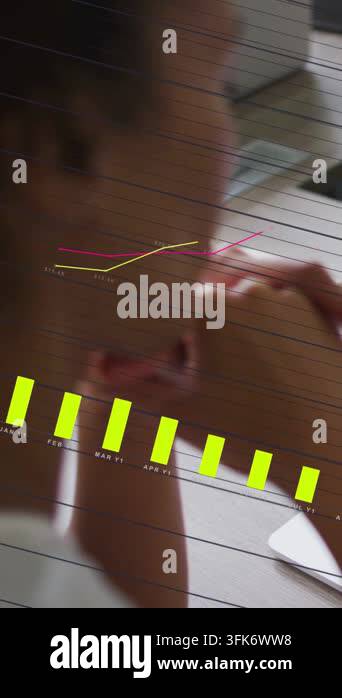 Technical Data Visualization Vertical video: Woman at desk touching chin and reviewing tech data ...