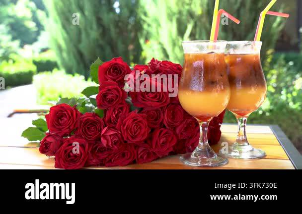 Bright Red Html Two drinks with ice sit next to a bouquet of red roses in a sunny ...