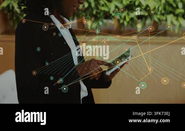 Businesswoman tapping tablet in lounge, animating nodes and lines from ...