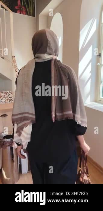 Woman Wearing Hijab Walking Up Wooden Stairs in Bright Interior Stock ...