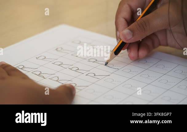 Child Practicing Handwriting by Tracing the Letter R Stock Video ...
