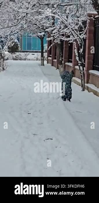 Snow Rumer Video of a baby running through the snow. Vertical lifestyle video of a ...