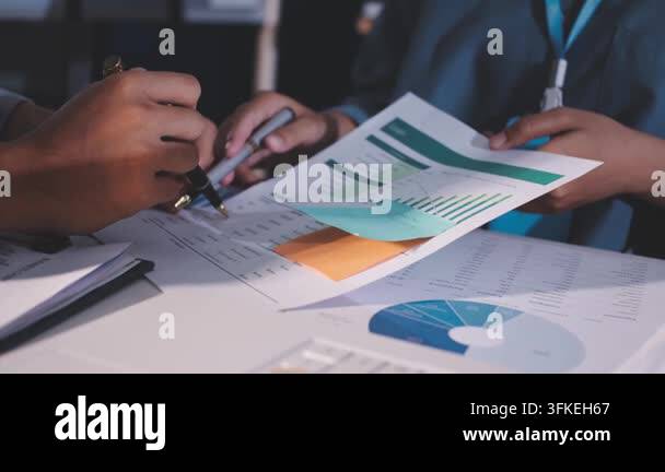business team discussing financial charts and graphs on a desk Stock ...