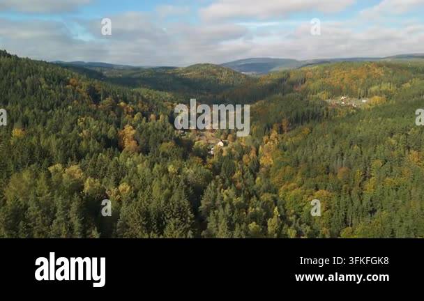 High Angle Aerial View of Lush Green Forest Rolling Over Hills Under ...