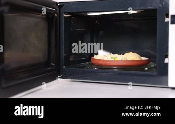 Cook'd Rice Modern microwave with cooked rice and chicken on countertop in kitchen ...