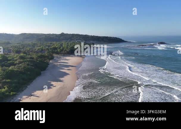 Aerial drone view of a tropical beach bay, turquoise water rolling into ...