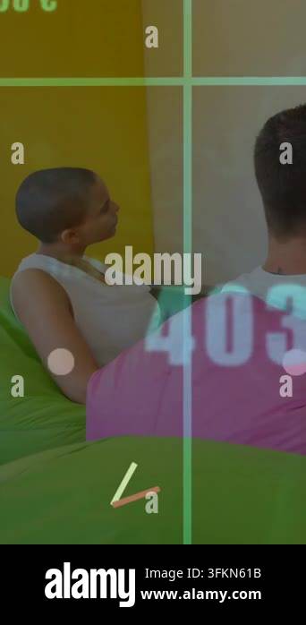 Technical Data Visualization Vertical video: Projecting animated charts on wall while pair on green ...