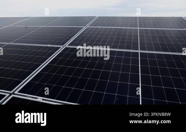 Close-up aerial view of a large solar panel array on a cloudy day ...