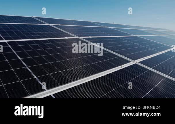 Close-up aerial view of a solar panel array under a clear blue sky ...