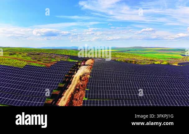 Aerial view of solar panel array reaching distant hills. Drone shot of ...