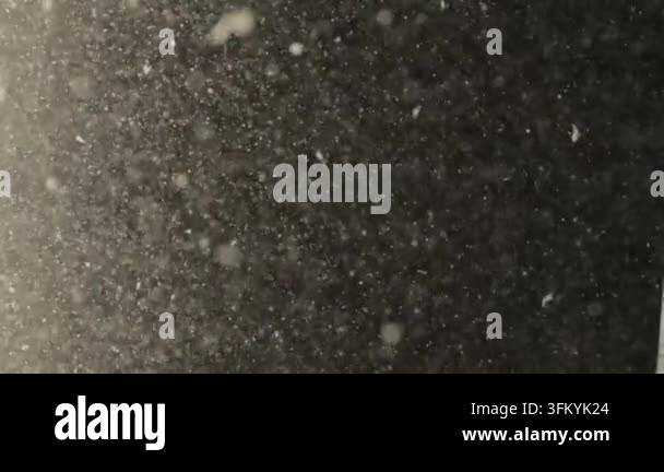 Falling snowflakes against dark background Stock Video Footage - Alamy