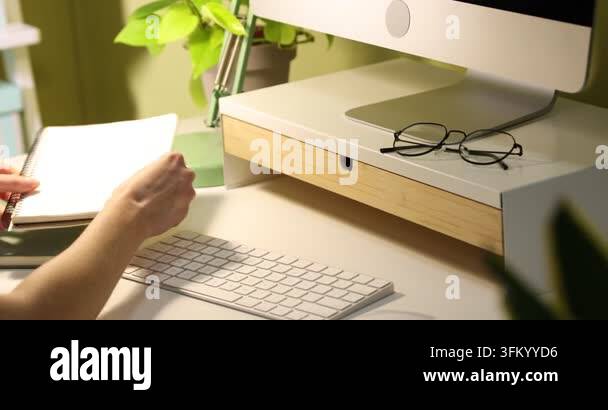 Computer Sdreem Riser Woman taking highlighter from drawer of under monitor riser at desk ...