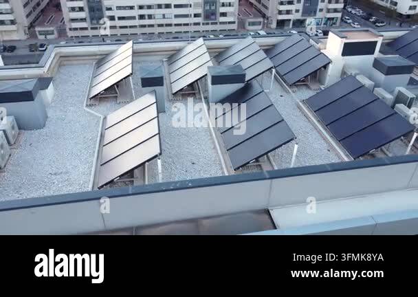 Modern solar hot water panels installed on the roof of a contemporary ...