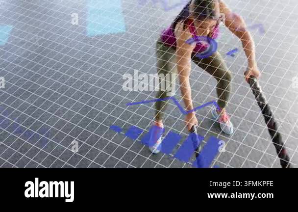 Woman starting battle-ropes waves on gym grid, emerging blue charts ...