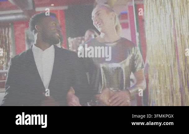 Man and woman walking entering frame, scanline revealing balloons while ...