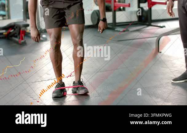 Gym client placing pink band doing one-leg march for balance coach ...