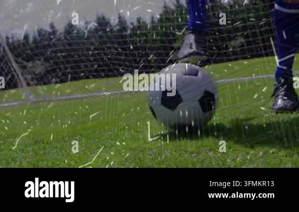 Male soccer player pressing foot and rolling ball toward net, training ...