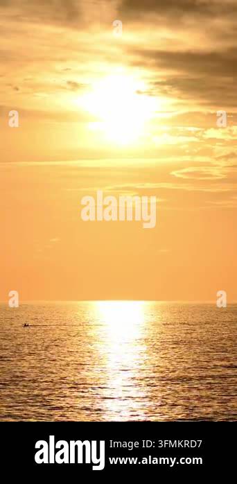 Sun setting over calm sea with golden reflection on water Stock Video ...