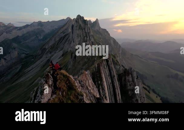 A couple experience breathtaking landscapes as the sun sets over ...