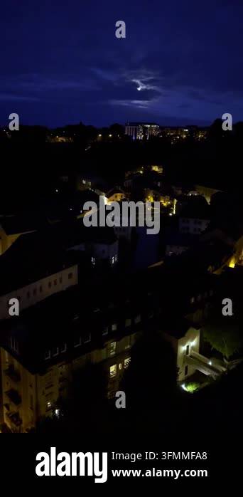 Luxembourg city skyline at night with glowing lights and moon. High ...