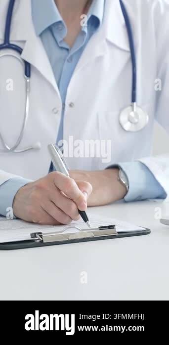 Note Writing Pad Medical practitioner writing notes on a clipboard while surrounded by a ...