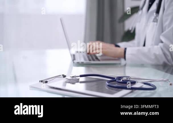 Back Rounds For Notebook Stethoscope and medical clipboard are lying on the glass table while ...