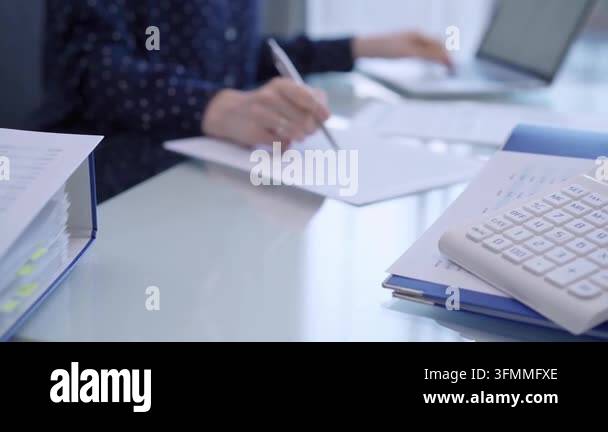 Back Rounds For Notebook Calculator and binders of financial papers are waiting to be processed ...