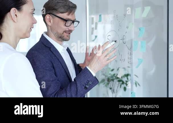 Business colleagues collaborating on strategic project during a meeting ...