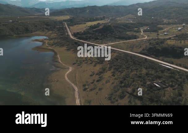 A drone glides over a partially drained reservoir in Argentina, its ...