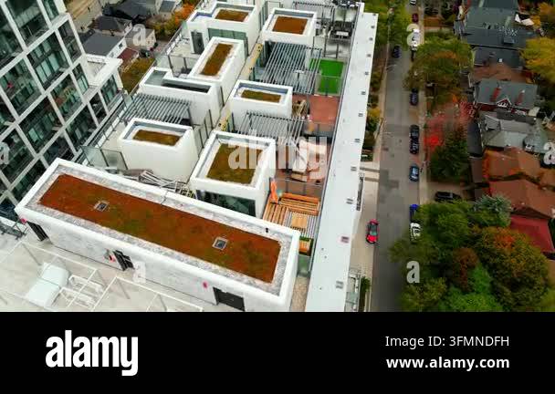 Aerial view of a modern apartment building with green roofs and a ...