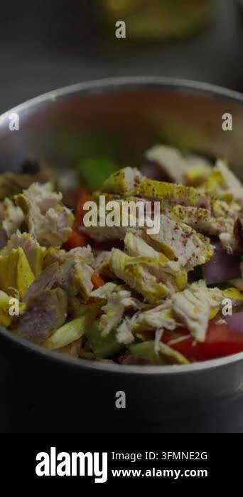 Close up of chopped seasoned chicken with red onions and peppers Stock ...