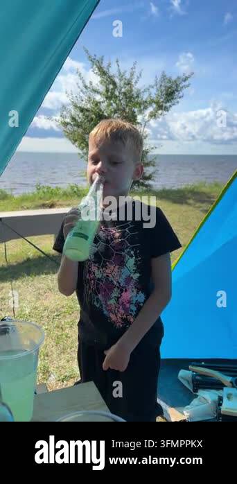 Reusable Container Vector Tuja, Latvia - July 22, 2026:Young boy drinks from a reusable bottle ...