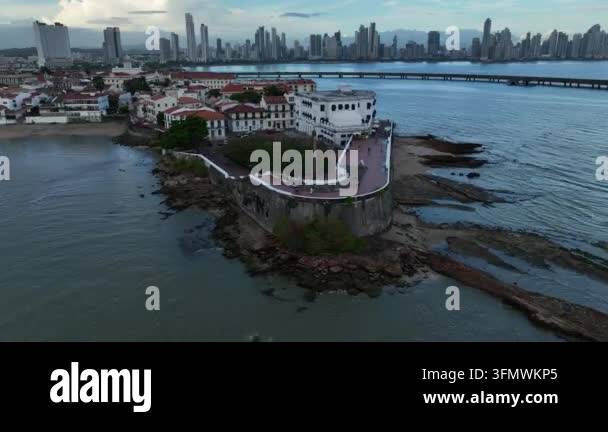 Aerial view of historic buildings on a rocky coastline with a modern ...