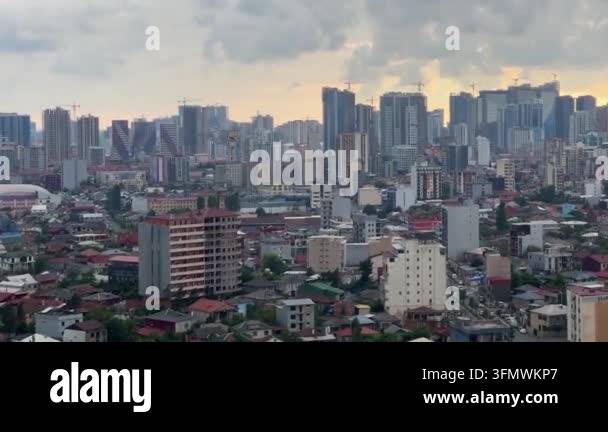 Wide aerial view of a sprawling city with numerous high rise buildings ...