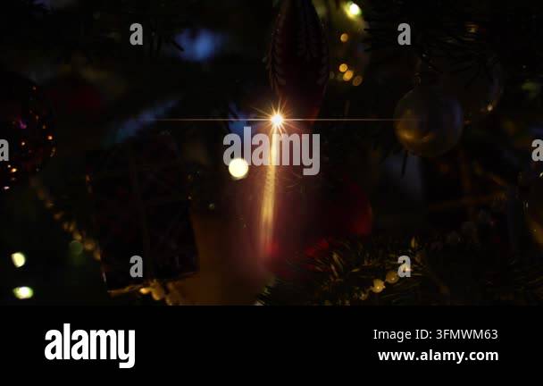 Close-up of a decorated Christmas tree with bokeh lights and a lens ...