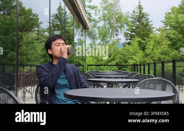 Reusable Container Vector A man sits at an outdoor cafe table, drinking from a reusable water ...